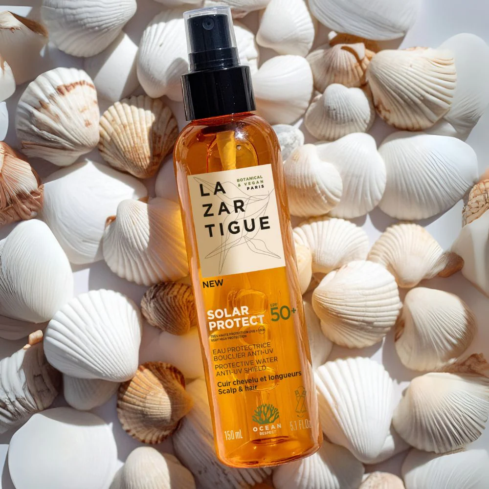 Spray solaire SPF 50+ avec coquillages.